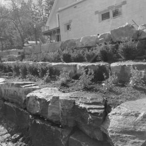 Tiered stone retaining wall with landscaping