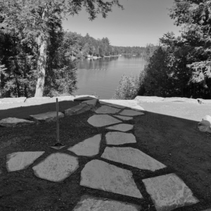 Stone path leading to lakeside forest view